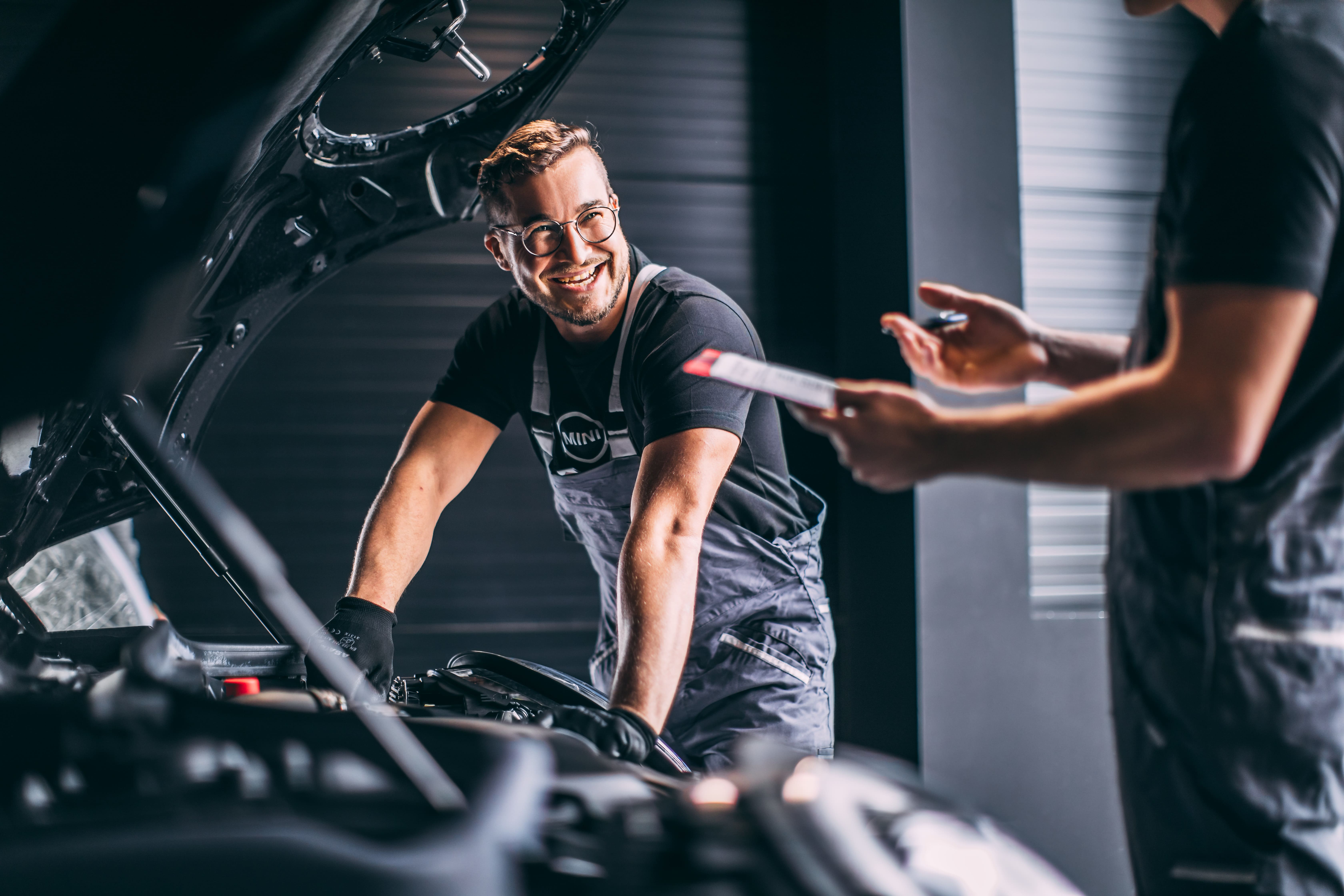 MINI 3-door hatchback car being serviced by a man with a smile